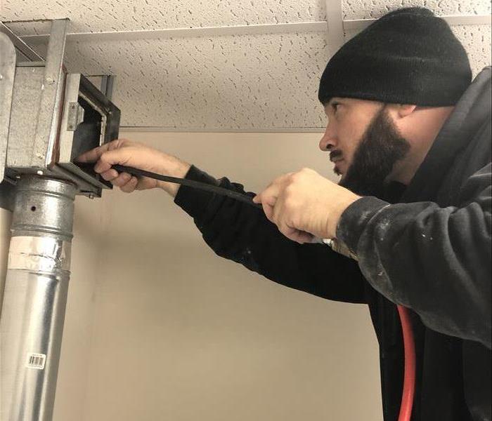 SERVPRO technician cleaning the air duct